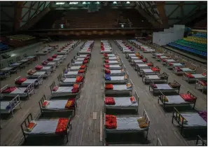  ?? (AP/Dar Yasin) ?? Beds sit ready at an indoor stadium converted into a covid-19 treatment center Wednesday in Srinagar in Indian-controlled Kashmir. India’s daily deaths have nearly tripled in the past three weeks.