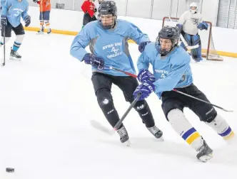  ?? JASON MALLOY ?? Avon View Avalanche defencemen Brayden Joudrey, left, and Carter Hood battle for the puck during a recent practice at the West Hants Sports Complex.