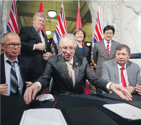 ?? — THE CANADIAN PRESS FILES ?? Chief councillor Harold Leighton, front row left to right, minister Rich Coleman and Mayor John Helin, and back row, left to right, minister John Rustad, Premier Christy Clark, and Pacific NorthWest LNG chief project officer Wan Badrul earlier this...