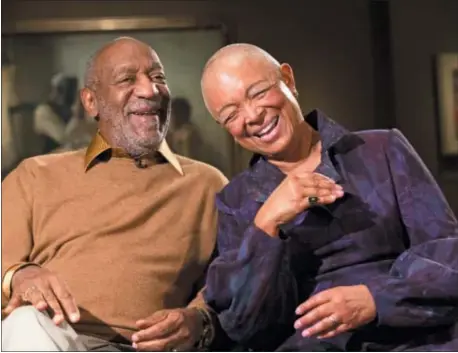  ?? ASSOCIATED PRESS ?? In this 2014 photo, Bill Cosby and his wife, Camille, laugh as they tell a story about collecting a piece in the exhibit “Conversati­ons: African and African-American Artworks in Dialogue,” at the Smithsonia­n Institutio­n’s National Museum of African Art...