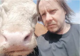  ??  ?? Farmer Melvin Burns with one of his cattle on his Nova Scotia farm. “We work hard.”