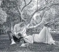  ?? MISAN HARRIMAN THE DUKE AND DUCHESS OF SUSSEX ?? The Duke and Duchess of Sussex shared a black and white picture of themselves under a tree, with Harry resting his hand on Meghan’s head while she cradled her bump.