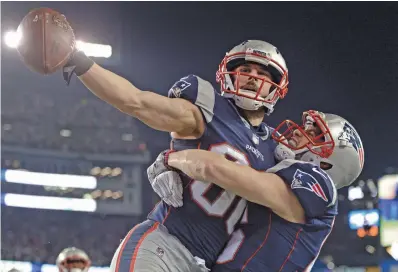  ?? STAFF PHOTO BY CHRISTOPHE­R EVANS ?? SQUEEZE PLAY: Danny Amendola gets a big hug from Chris Hogan after scoring the game-winning touchdown in the fourth quarter of yesterday’s AFC title game in Foxboro.