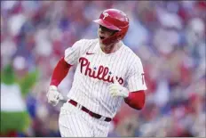  ?? AP photo ?? The Phillies’ Rhys Hoskins celebrates after hitting a threerun homer in the third inning of Philadelph­ia’s 9-1 win over the Atlanta Braves in Game 3 of their NLDS on Friday.