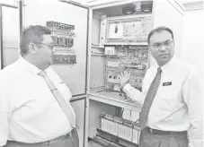  ??  ?? Amarjit (right) showing components that were stolen from one of the department’s transmissi­on systems.