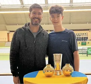  ?? ?? »Eric (right) with his dad and tennis coach, Bruce Lorimer, after winning the doubles championsh­ip in Stockholm, Sweden