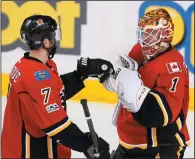  ?? THE CANADIAN PRESS/LARRY MACDOUGAL ?? Calgary Flames goalie Brian Elliott, right, celebrates with teammate TJ Brodie after defeating the Colorado Avalanche in NHL action in Calgary, Alta., Monday.