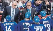  ?? DARRYL DYCK THE CANADIAN PRESS ?? Former Canucks’ head coach Willie Desjardins, top right, speaks to his players as assistant coach Perry Pearn listens during a 2016 game.