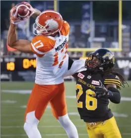  ?? JOHN RENNISON, THE HAMILTON SPECTATOR ?? The Lions’ Nick Moore catches a Tavis Lulay pass in the end zone over Ticats’ Ethan Davis.