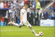  ?? Francisco Leong / AFP/Getty Images ?? Russia’s Denis Cheryshev shoots and scores a penalty kick during the penalty shootout against Spain on Sunday.