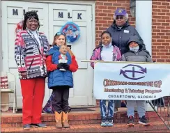  ?? ?? YWTSA Executive Director Pamela Baker-King (from left) and Coy Frasier join Rev. Willie Mae Simpson from Crossroads: Bridging the Gap and other children at the Annual MLK Jr. “Youth” Infusion and Community Service Rally in Cedartown on Saturday, Jan. 15.