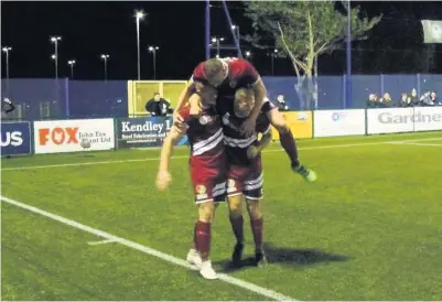  ??  ?? ● Caernarfon Town players celebrate Jamie Breese’s winner at Airbus UK