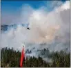  ?? JOE BRADSHAW — BUREAU OF LAND MANAGEMENT ?? A helicopter provides air support Sept. 9to firefighte­rs on the ground by supplying both water and retardant. Here, a load is dropped on the Dixie Fire.