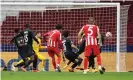  ??  ?? João Félix scores Atlético’s third goal to seal their win against RB Salzburg. Photograph: Ángel Martínez/Getty Images