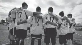  ?? PATRICK TEHAN/STAFF ?? The White team huddles before a soccer match hosted by Archbishop Mitty High School students featuring local refugee youth in San Jose on Saturday.