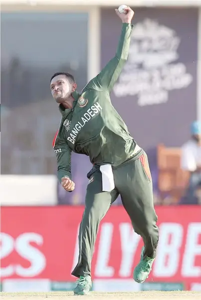  ?? — AFP ?? Bangladesh’s Shakib al Hasan delivers a ball during the ICC Twenty20 World Cup match against Papua New Guinea at the Oman Cricket Academy Ground in Al Amerat, Muscat on Thursday.