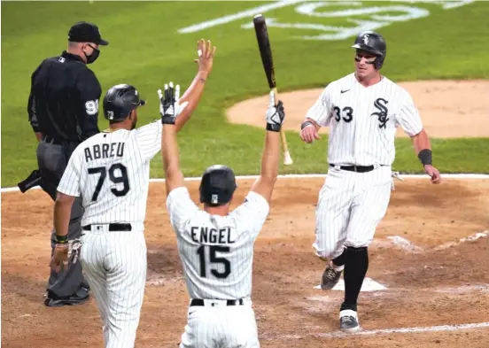  ?? CHARLES REX ARBOGAST/AP ?? Adam Engel celebrates with Jose Abreu and James McCann after McCann and Abreu scored on a single by Luis Robert in the third inning Tuesday night.