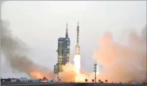  ?? STRINGER/AFP ?? A carrier rocket transporti­ng the spacecraft Shenzhou 11 blasts off from the launchpad at the Jiuquan Satellite Launch Center in northweste­rn China last month.
