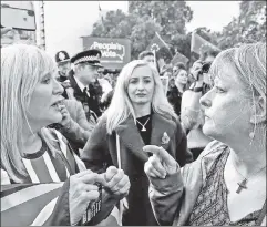  ??  ?? Torn apart: At a London rally, three years since the referendum, pro-Brexit and Remainer protesters face off in heated debate.