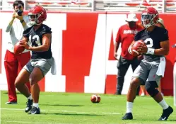  ?? Butch Dill/Associated Press ?? ■ Alabama quarterbac­ks Jalen Hurts (2) and Tua Tagovailoa (13) run drills during a NCAA college football practice on Saturday in Tuscaloosa, Ala.