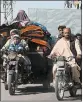  ?? GETTY-AFP ?? People flee Monday from Afghanista­n’s Helmand province amid clashes between Taliban fighters and Afghan security forces. Violence across the country has ticked up recently.