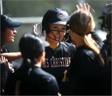  ?? PHOTO BY ANDY HOLZMAN ?? Oaks Christian’s Lily Knox receives congratula­tions after hitting a three-run home run in the first inning against Newbury Park on Thursday.