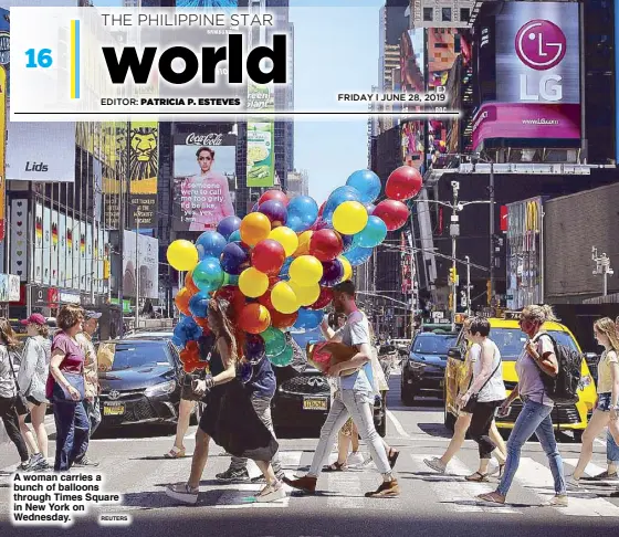  ?? REUTERS ?? A woman carries a bunch of balloons through Times Square in New York on Wednesday.