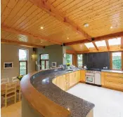  ??  ?? The split-level kitchen and dining room with a curved countertop