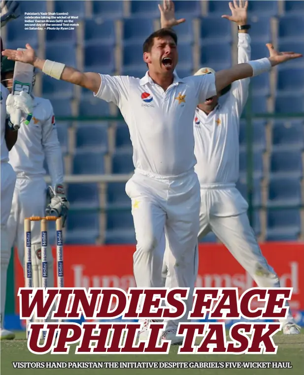  ?? — Photo by Ryan Lim ?? Pakistan’s Yasir Shah (centre) celebrates taking the wicket of West Indies’ Darren Bravo (left) on the second day of the second Test match on Saturday.