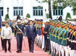  ?? (Richard Viñas) ?? ABE VISIT – President Duterte and Japan’s Prime Minister Shinzo Abe troop the line during welcome ceremonies for the Japanese leader in Malacañang Thursday. The two leaders are expected to discuss mutually important concerns, including the sensitive...