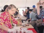  ??  ?? Namrata Nepal served traditiona­l Nepalese food at a booth at the University of New Mexico’s Internatio­nal Festival.