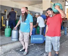  ?? Reuters ?? Queuing in Lebanon’s capital Beirut to fill gas cylinders. Countries that import fuel are most vulnerable to prices pressures