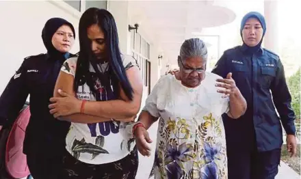  ?? PIC BY ABDULLAH YUSOF ?? The accused, P. Neela (second from right) and her daughter-in-law S. Indra (second from left) being taken to the Batu Gajah Magistrate’s Court yesterday.