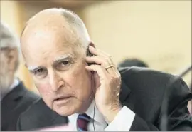  ?? Fred Dufour AFP/Getty Images ?? GOV. JERRY BROWN had temporaril­y halted the Board of Equalizati­on’s ability to hire and approve contracts after an audit found members had violated policies.