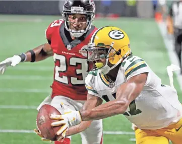  ?? JIM MATTHEWS/USA TODAY NETWORK-WISCONSIN ?? Packers receiver Davante Adams (17) makes a diving catch for a touchdown past Falcons cornerback Robert Alford (23) at Mercedes-Benz Stadium in Atlanta on Sunday.