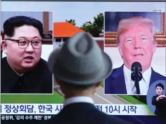  ??  ?? „ A man watches a news programme in Seoul, South Korea, discussing the historic meeting.