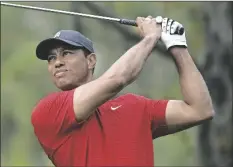  ?? PHOTO/ PHELAN M. EBENHACK
AP ?? Tiger Woods watches his tee shot on the fourth hole during the final round of the PNC Championsh­ip golf tournament Dec. 20, 2020, in Orlando, Fla. Woods posted a video on social media Nov. 21 of him swinging a wedge for the first time since badly injuring his right leg in a Feb. 23 car accident in Los Angeles.