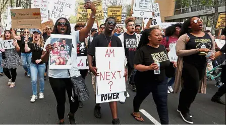  ?? — Reuters ?? We want justice: Protesters marching downtown after the funeral of police shooting victim Clark in Sacramento, California.