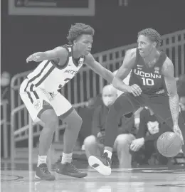  ?? COURTESY OF BUTLER UNIVERSITY ?? UConn's Brendan Adams tries to get around a Butler defender during the Huskies' 72-60 win on Saturday in Indianapol­is.