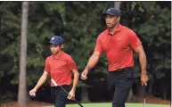  ?? Sam Greenwood / Getty Images ?? Tiger Woods, right, and Charlie Woods walk from the first green during Sunday’s final round of the PNC Championsh­ip in in Orlando, Fla.