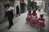  ?? ODED BALILTY / AP ?? Ultra-Orthodox Jewish girls wear costumes to celebrate the Jewish holiday of Purim in Jerusalem, Sunday.