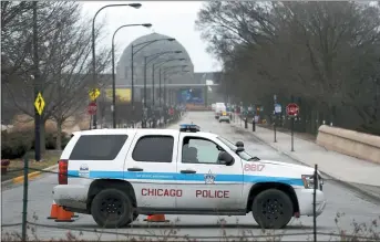  ?? CHARLES REX ARBOGAST — THE ASSOCIATED PRESS ?? A Chicago police officer blocks the road to the Adler Planetariu­m along Lake Michigan on Thursday.