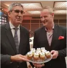  ?? (Noam Katz) ?? EUROLEAGUE CEO Jordi Bertomeu (left) presents a plate of cupcakes to Hilton Hotel’s Motti Verses.