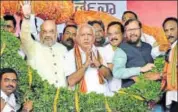  ?? PTI FILE ?? BJP chief Amit Shah with Karnataka chief and chief minister candidate BS Yeddyurapp­a and Union minister Prakash Javadekar at a rally in Mysuru in January.