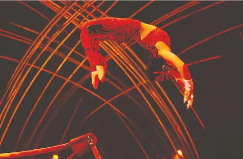  ??  ?? Laura-Ann Chong of Vancouver performs a move called the Korbut after famed Olympic gymnast Olga Korbut in a Cirque du Soleil show Amaluna in Santiago, Chile. Chong found herself without a job when the pandemic hit.