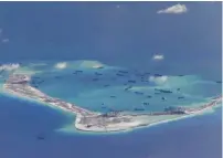  ?? (Reuters) ?? THIS US NAVY photo, taken in May 2015, shows what are believed to be Chinese dredging vessels in the disputed Spratly Islands in the South China Sea.
