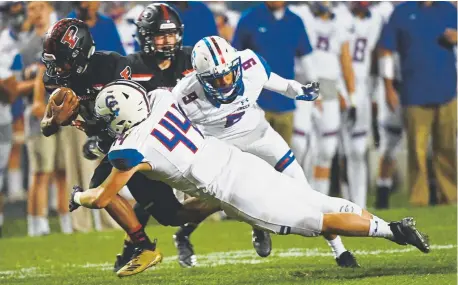  ?? Andy Cross, Denver Post file ?? Pomona Panthers running back Theorius Robison tries to gain extra yards against charging Cherry Creek Bruins middle linebacker Dade Bissell (44) and cornerback Damoni Jones during a game earlier this season.