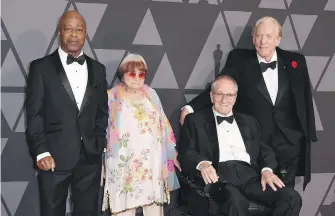  ??  ?? Charles Burnett, from left, Agnes Varda, Owen Roizman and Donald Sutherland arrive Saturday at the ninth annual Governors Awards in Los Angeles.