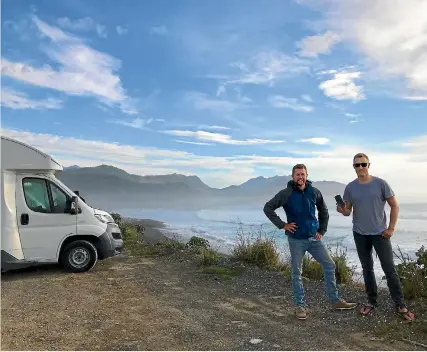  ??  ?? CamperMate founder Adam Hutchinson, left, with German freedom camper Hans Grohe who donated $5 to stay at a campsite near Kaiko¯ ura.