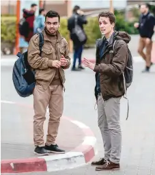  ?? — AFP ?? Italian student Riccardo Corradini (R) speaks with a friend at the Islamic University of Gaza in Gaza City.